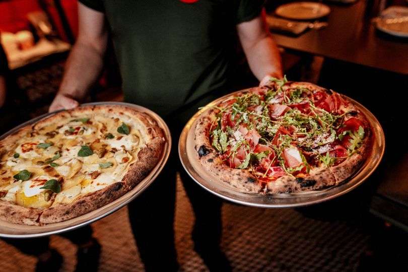 Man holding pizza
